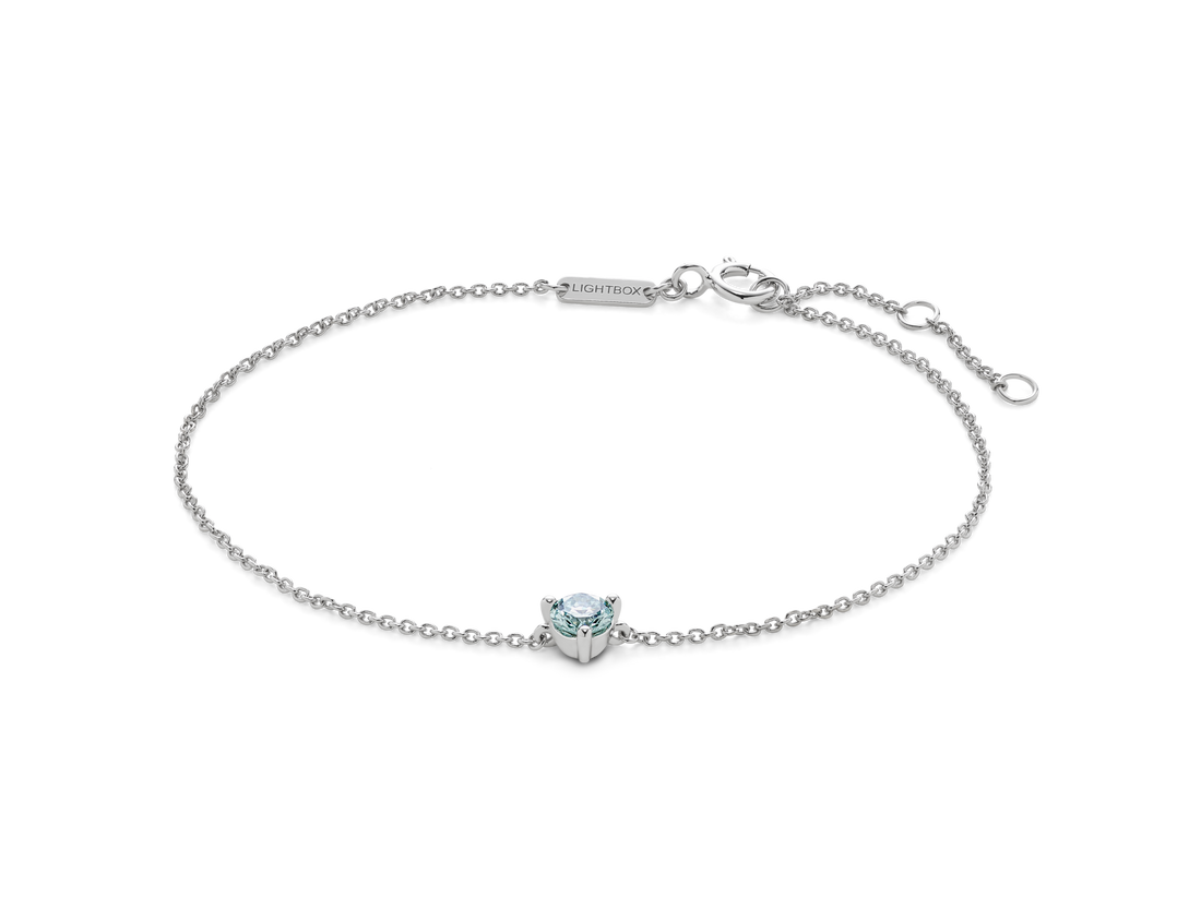 Front view of blue 0.25 carat round brilliant solitaire bracelet in 14k white gold