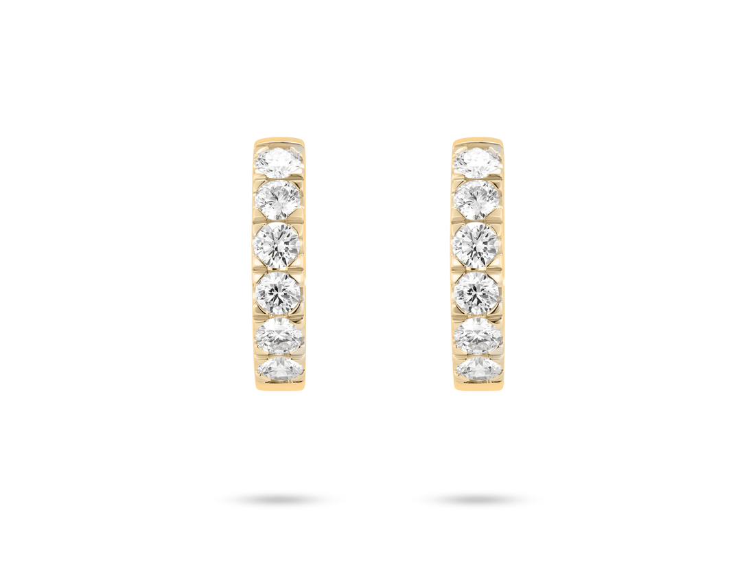 Front view of 1.2 carat total weight pavé huggie hoops in 14k yellow gold